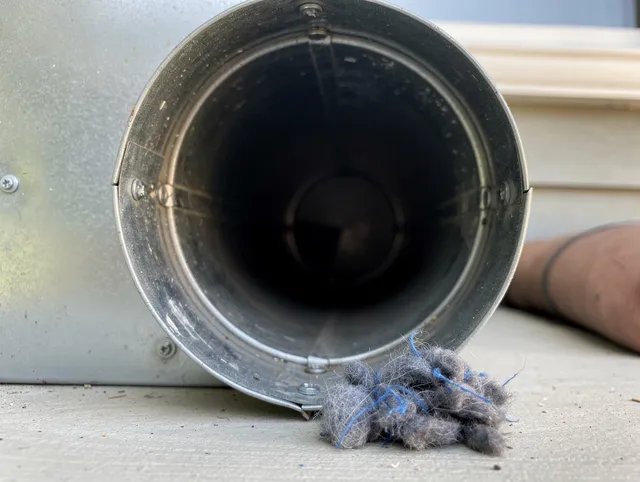 Beachwood Dryer Vent Cleaning technician using specialized equipment to clear severe dryer vent blockage in Beachwood